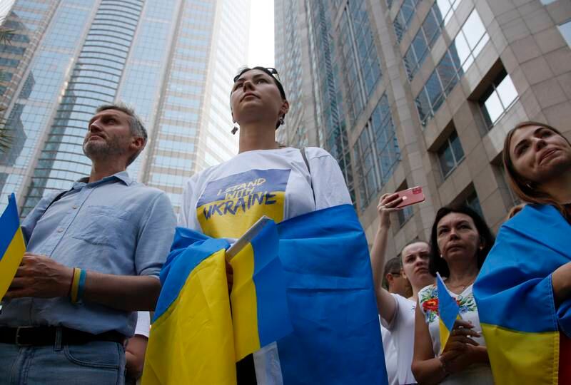 Supporters carry Ukrainian flags during a demonstration in Bangkok. EPA