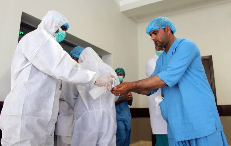 Hospital staff wear hazmet suits inside the coronavirus center in Kandahar, Afghanistan.  EPA
