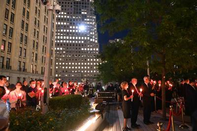 People hold candles in New York as they remember those who lost their lives in the attacks. AFP
