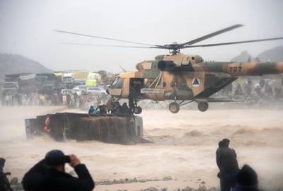 An Afghan military helicopter rescues people from atop an overturned truck in flooded area of Arghandab district in Kandahar province. AFP