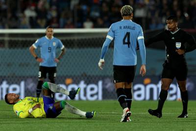 Neymar lies on the turf after being fouled during Brazil's game against Uruguay. AFP