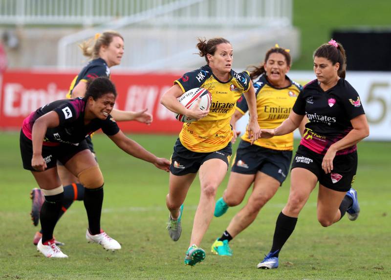 Dubai, United Arab Emirates - December 07, 2019: Alex Cook of Hurricanes beats the defence of the Emirates Firebirds Blue in the game between Dubai Hurricanes and Emirates Firebirds Blue in the Gulf womens final at the HSBC rugby sevens series 2020. Saturday, December 7th, 2019. The Sevens, Dubai. Chris Whiteoak / The National