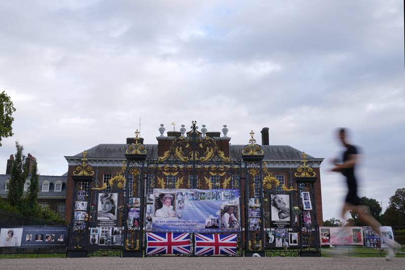 Portraits of Princess Diana adorn the gates of Kensington Palace, west London. This week marks the 25th anniversary of Princess Diana's death in a car crash in Paris. AP