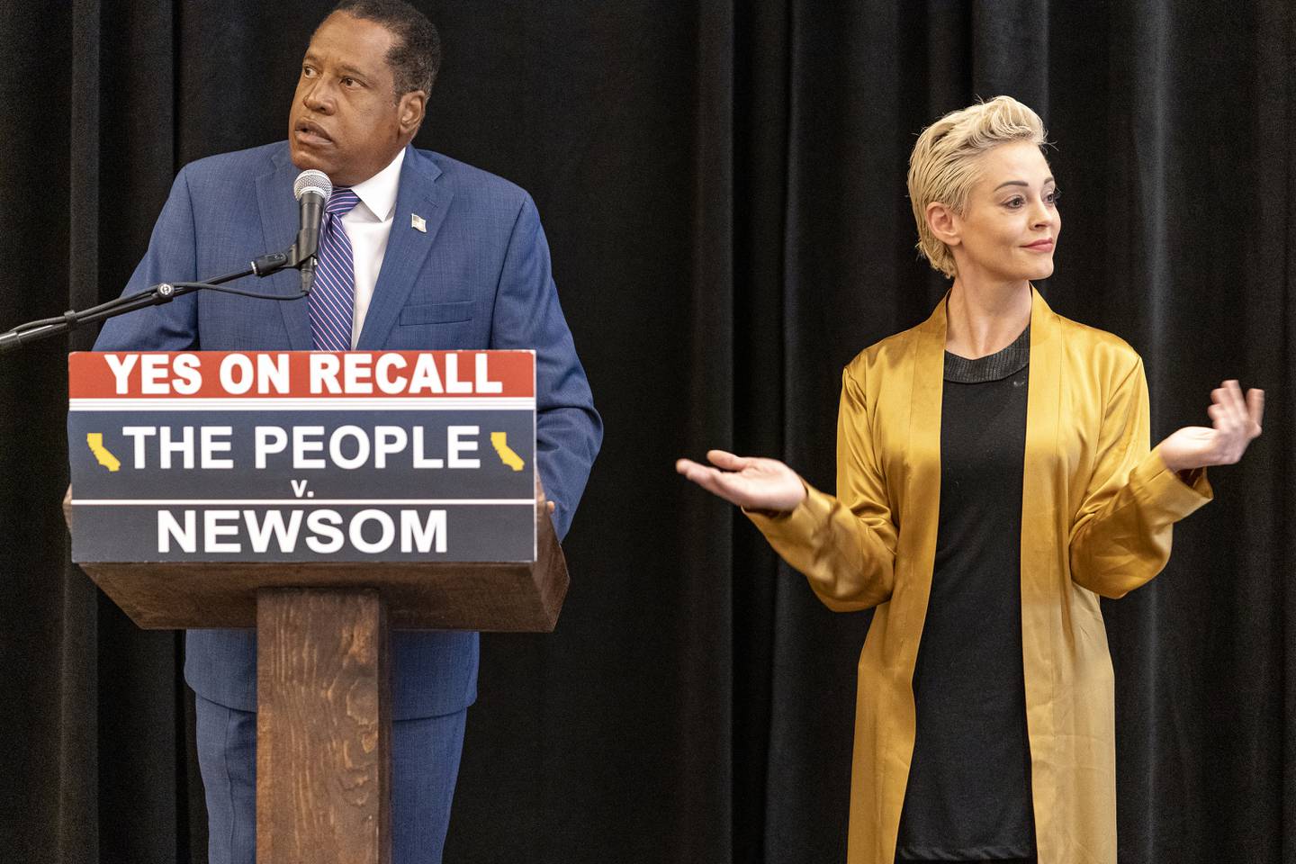 Former actor and activist Rose McGowan listens to Larry Elder, who is running to replace Democratic Governor Gavin Newsom, at a press conference in Los Angeles. AP