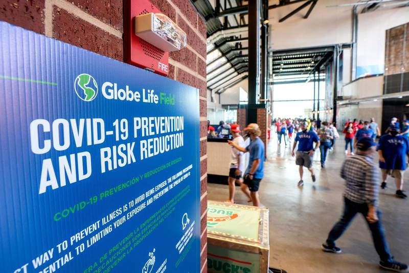 A Covid-19 sign hangs in the concourse of Globe Life Field before the Texas Rangers' home opener baseball game against the Toronto Blue Jays, in Arlington, Texas. AP