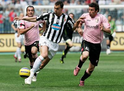 Juventus' Zlatan Ibrahimovic (L) is challenged by Palermo's Andrea Barzagli during their Italian Serie A soccer match at the Delle Alpi stadium in Turin May 7, 2006. REUTERS/Tony Gentile