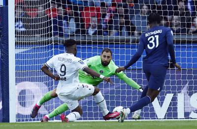 Rennes' Arnaud Kalimuendo scores their second goal past Gianluigi Donnarumma. Reuters