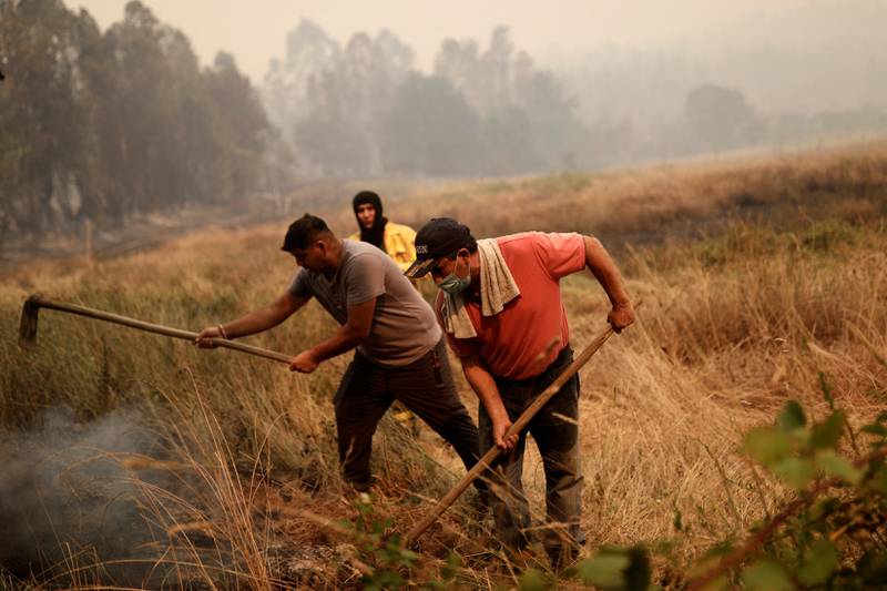 Local residents work as the wildfire burns 