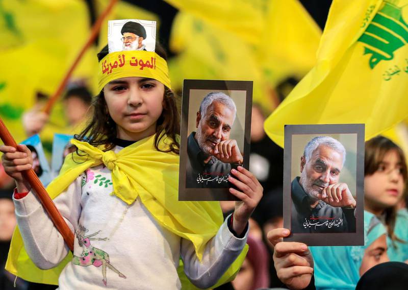 Supporters of Hezbollah hold photos of slain Iranian general Qassem Suleimani as they listen to a televised speech by Hezbollah leader Hassan Nasrallah in a southern suburb of the Lebanese capital Beirut. EPA