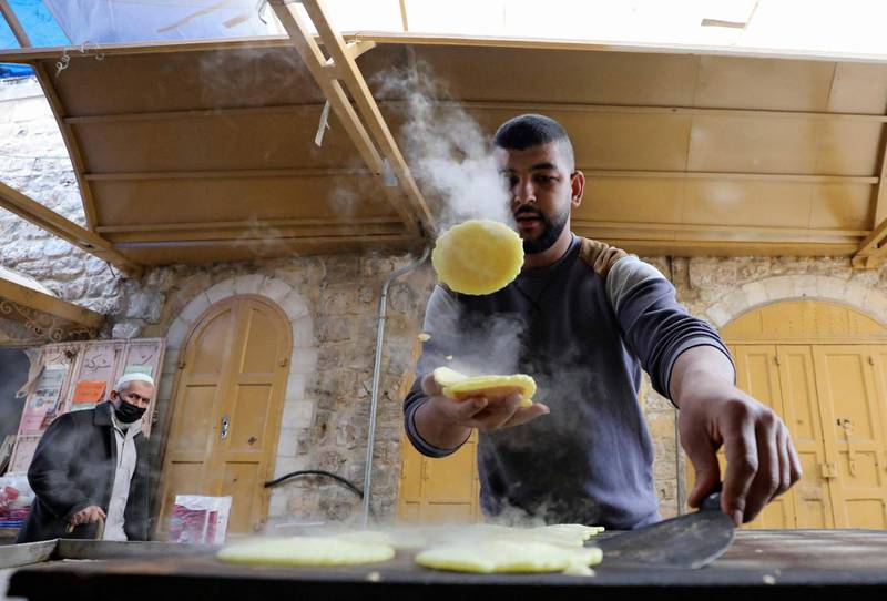 A Palestinian man prepares Qatayef, traditional pancakes that are popular during the fasting month of Ramadan, in the occupied West Bank town of Hebron, ahead of the holy month.  AFP