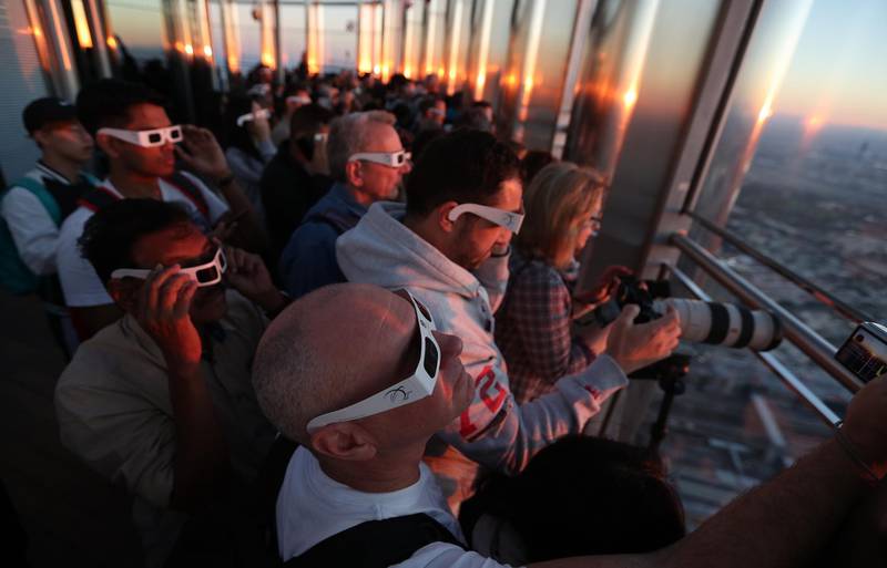 Those with a head for heights watched the solar eclipse from the 124th floor of Burj Khalifa. EPA