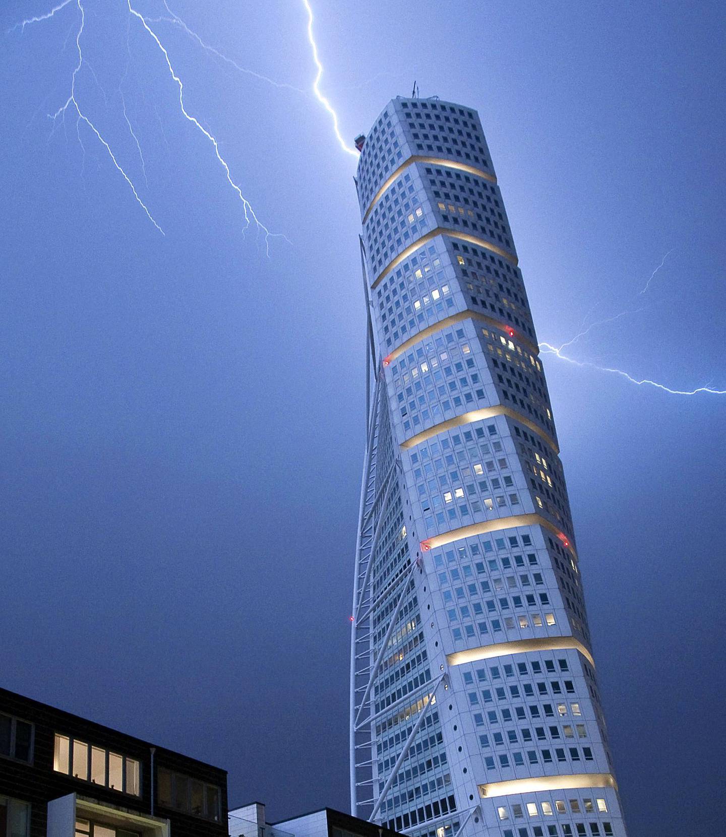 Lightning strikes the 190 m (623 ft)-high Turning Torso building in Malmo early morning on June 7, 2011. As the unseasonally hot weather was replaced by cooler winds, heavy rain and thunderstorms struck Sweden's South-west coast. AFP PHOTO / SCANPIX - JOHAN NILSSON (Photo by JOHAN NILSSON / SCANPIX SWEDEN / AFP)