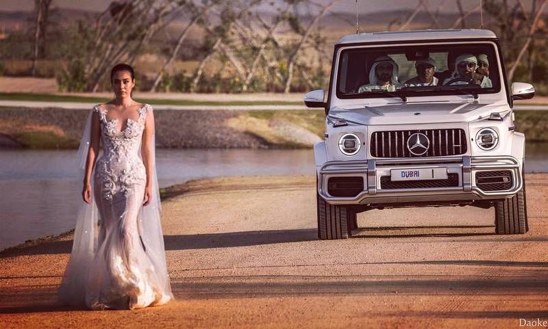 Sheikh Mohammed bin Rashid can be seen driving behind a woman dressed in a wedding dress at the Al Qudra group wedding. Instagram / Yu Zhang