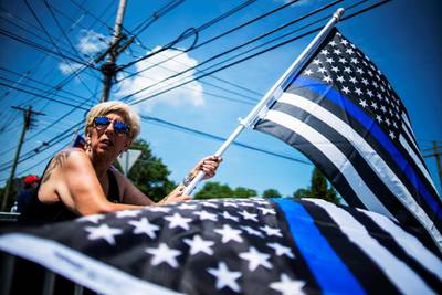A woman takes part in a rally to support U.S. President Donald Trump and the Back the Blue in Bedminster, New Jersey, U.S., July 26, 2020. REUTERS/Eduardo Munoz