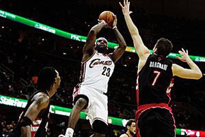 Cleveland Cavaliers' LeBron James, in white, was too hot for the Toronto Raptors to handle.