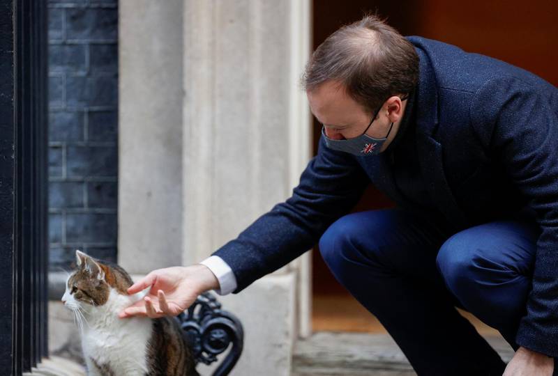 Britain's Health Secretary Matt Hancock pets Larry the cat outside Downing Street, in London, Britain, January 6, 2021. REUTERS/John Sibley