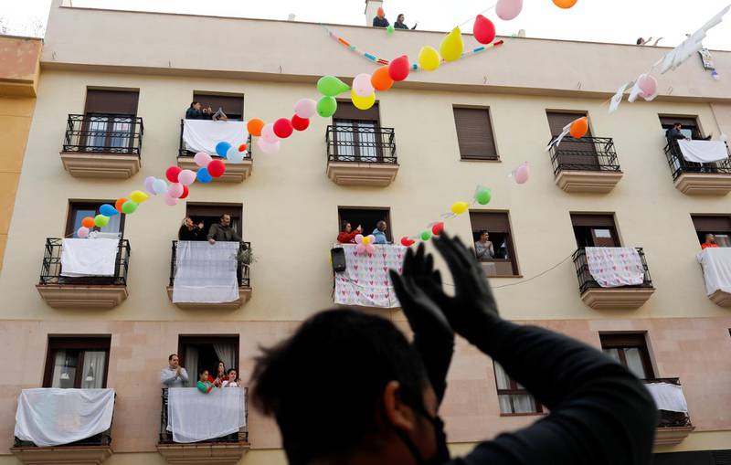Neighbours celebrate the engagement of Juan Manuel Zamorano, 32, and Elena Gonzalez, 31, after she proposed to him at the balcony of their house in downtown Ronda, southern Spain. Reuters