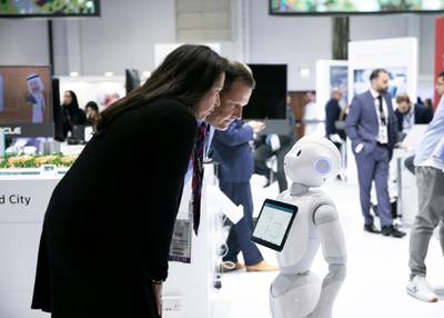 DUBAI, UNITED ARAB EMIRATES. 06 OCTOBER 2019. A man and a woman intercat with a robot at Oracle’s booth during Gitex Technology Week at Dubai World Trade Center.(Photo: Reem Mohammed/The National)Reporter:Section: