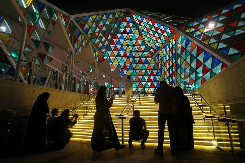 Visitors take pictures of an installation at the Noor Riyadh festival, in the capital city of Saudi Arabia. Reuters