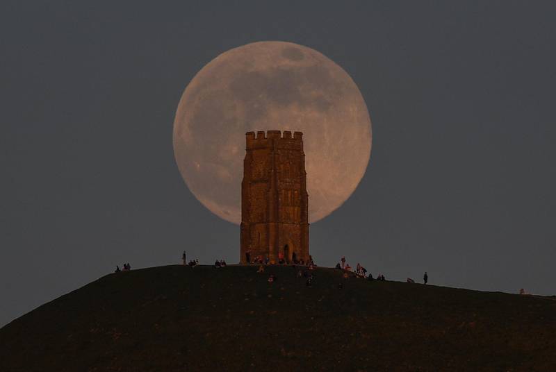A full pink supermoon rises behind Glastonbury Tor in Glastonbury, England. Getty Images