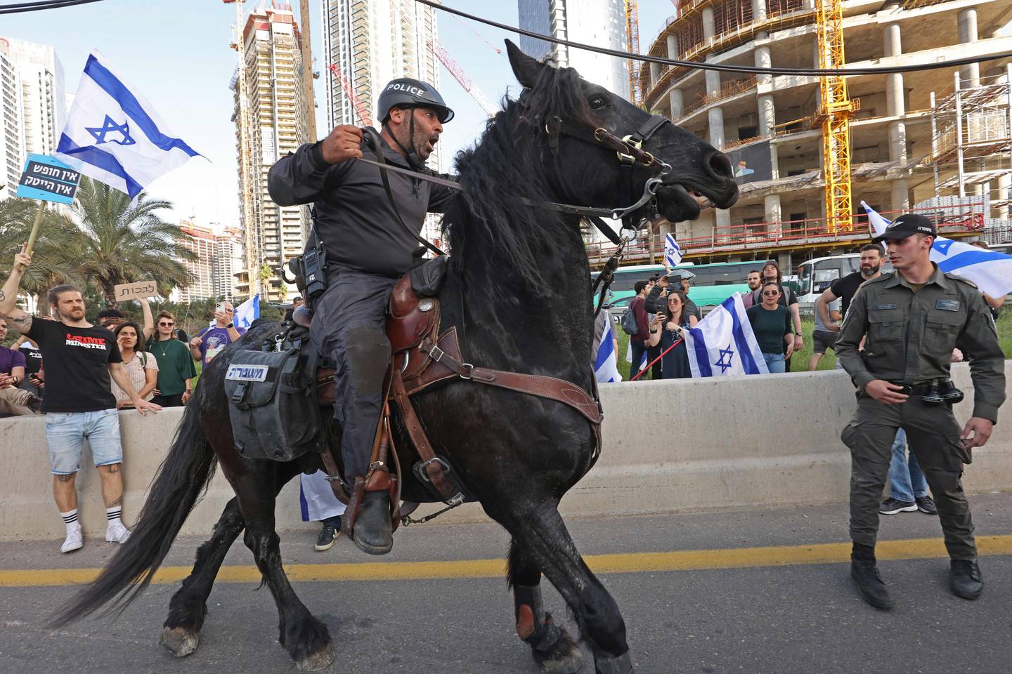 Israeli mounted police disperse protesters during a demonstration against the government's controversial justice reform bill in Tel Aviv on March 1, 2023. AFP