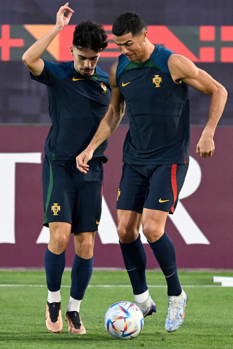 Portugal's Cristiano Ronaldo and Vitinha take part in a training session at Al Shahaniya training centre. AFP