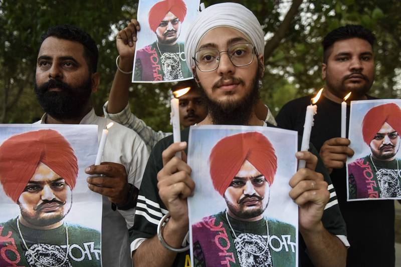 People pay tribute to Punjabi singer Sidhu Moose Wala at a candlelight vigil in Amritsar, India. AFP