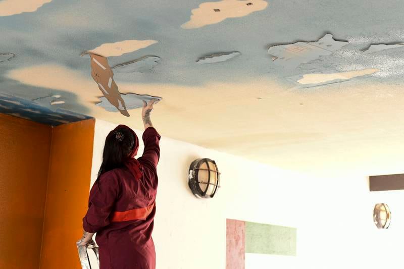 An inmate creates a ceiling mural. The programme aims to develop talent and self-confidence, so the women can earn a living after leaving prison. 