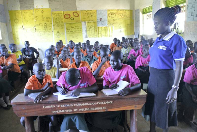 ADJUMANI DISTRICT, Uganda, Tuesday, November 28, 2017 // Ugandan teacher Patricia Ijore  supervises South Sudanese pupils at Liberty Primary School as they wait to meet with the Dubai Cares delegation to the Ayilo II refugee settlement in Northern Uganda Tuesday, Nov. 28, 2017. Dubai Cares partnered with Plan International to build new classrooms at the school for South Sudanese refugees. (Roberta Pennington/The National)