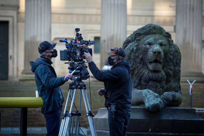 Two cameramen check equipment outside St. George's Hall. Getty Images