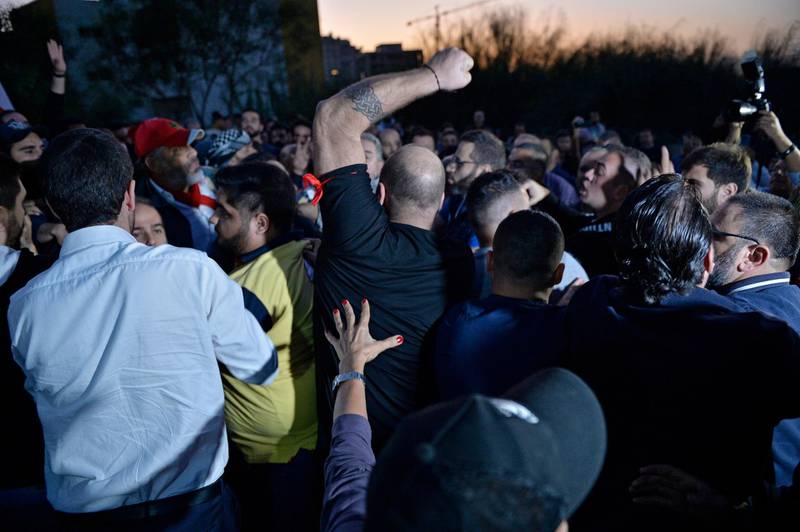 Supporters of the Lebanese President Michel Aoun (R) scuffle with anti-government protesters (L) blocking the highway leading to the Presidential palace during a protest to demand the formation of a new government in Baabda.  EPA