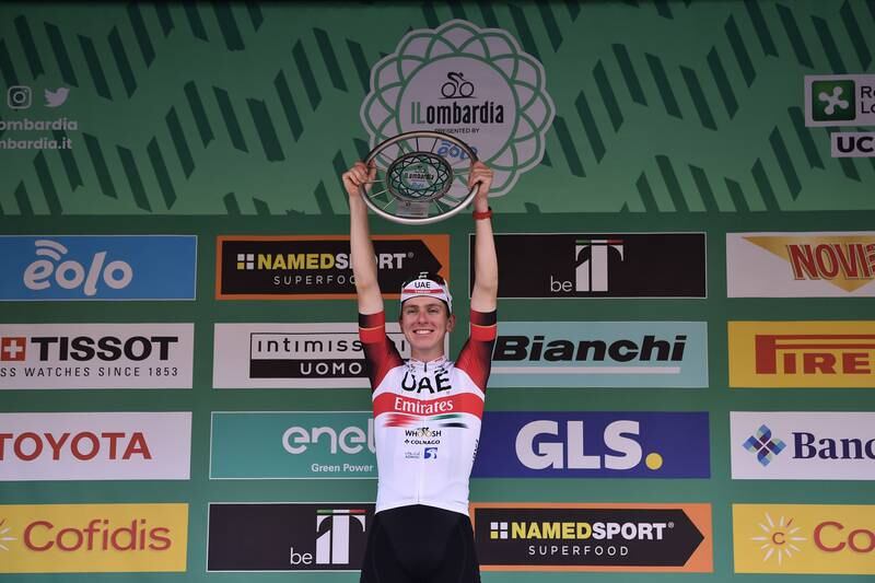 Tadej Pogacar lifts the Giro di Lombardia trophy after winning the race. EPA