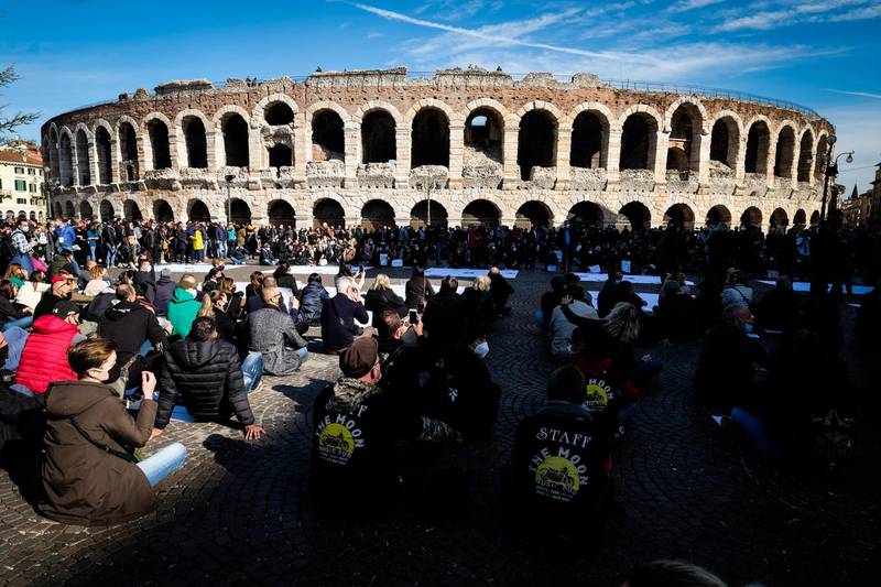Owners of restaurants and event organisers gather to protest at rally in front of the colosseum in Verona. EPA