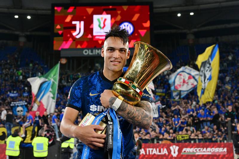 Inter Milan's Lautaro Martinez celebrates winning the Coppa Italia with the trophy. Reuters