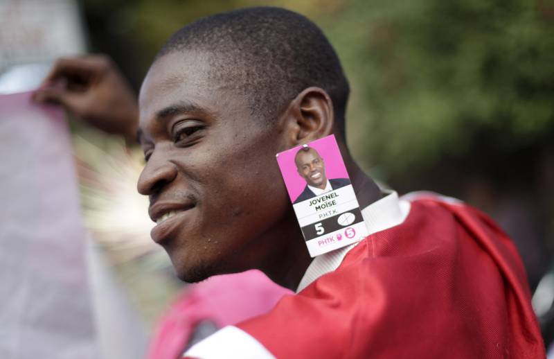 A supporter of Jovenel Moise in Port-au-Prince in 2016. Mr Moise was running for president at the time.