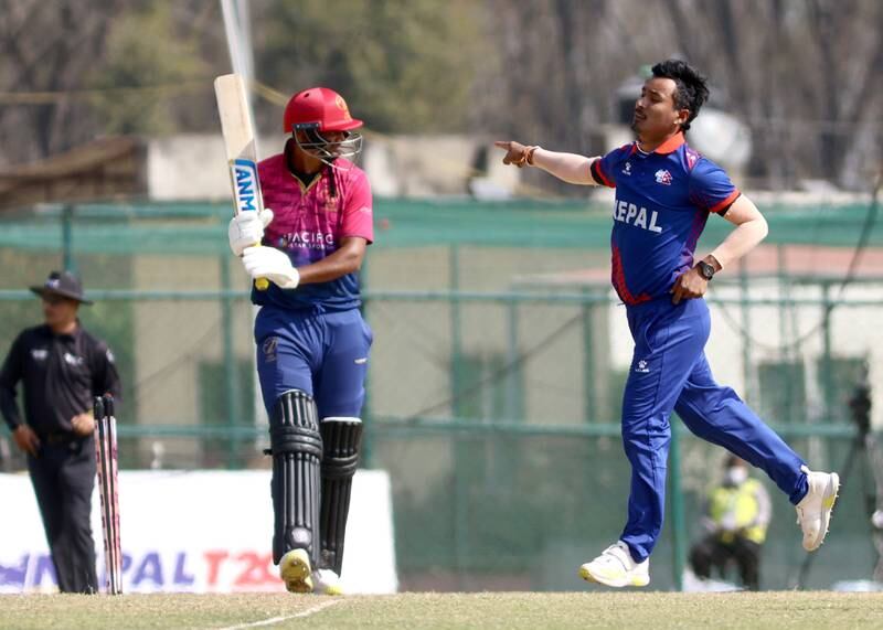 Nepal's Sompal Kami celebrates wicket of UAE batter Sabir Ali for seven.