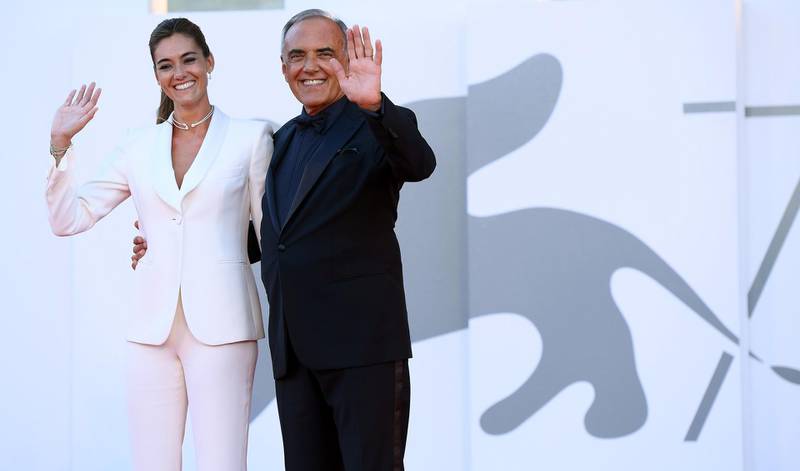 Festival director Alberto Barbera and his wife walk the red carpet ahead of the Opening Ceremony during the 77th Venice Film Festival on September 2, 2020 in Venice, Italy. EPA