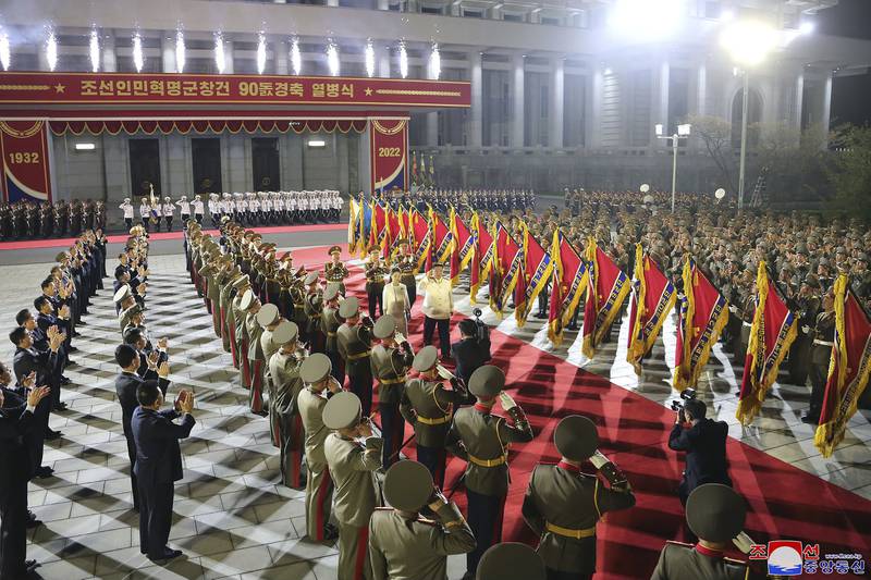 North Korean leader Kim Jong-un and his wife Ri Sol-ju review an honour guard during a military parade to mark the 90th anniversary of North Korea's army in Pyongyang. AP