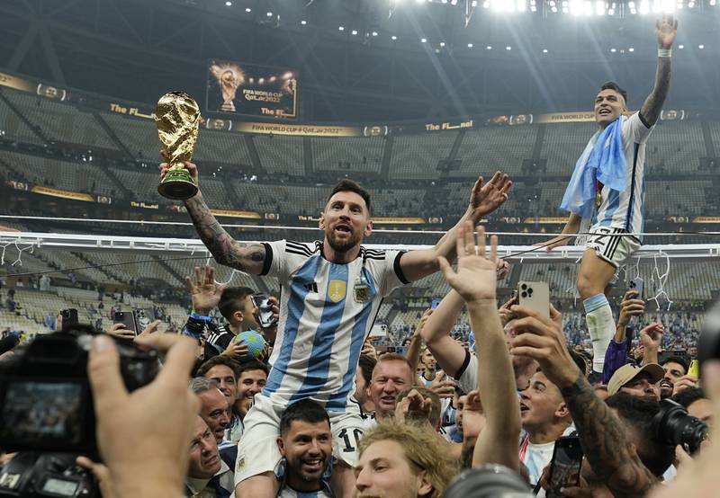 Argentina's Lionel Messi holds aloft the World Cup trophy on December 18. AP