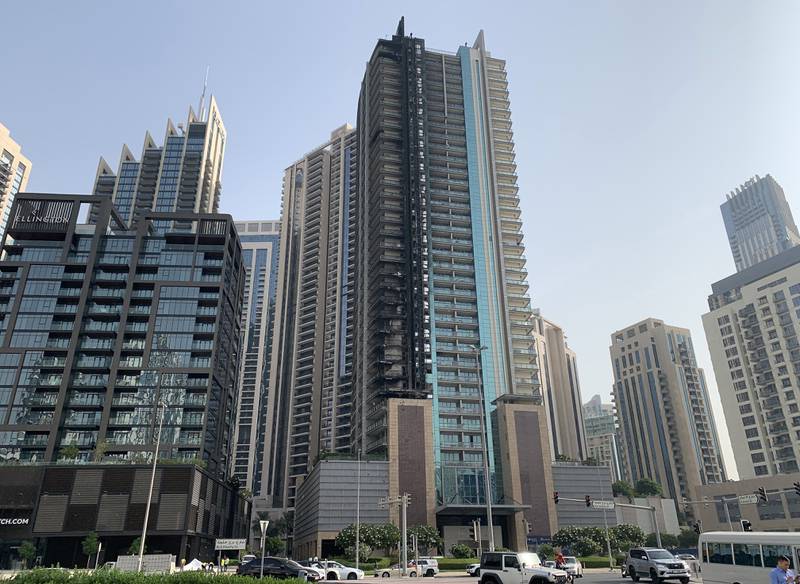 The charred facade of the residential tower that caught fire in Downtown Dubai. Pawan Singh / The National