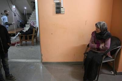A woman sits in shock at a make-shift hospital in Kafr Batna following Syrian government bombardments on the besieged Eastern Ghouta rebel enclave on the outskirts of the capital Damascus. Ammar Suleiman / AFP Photo