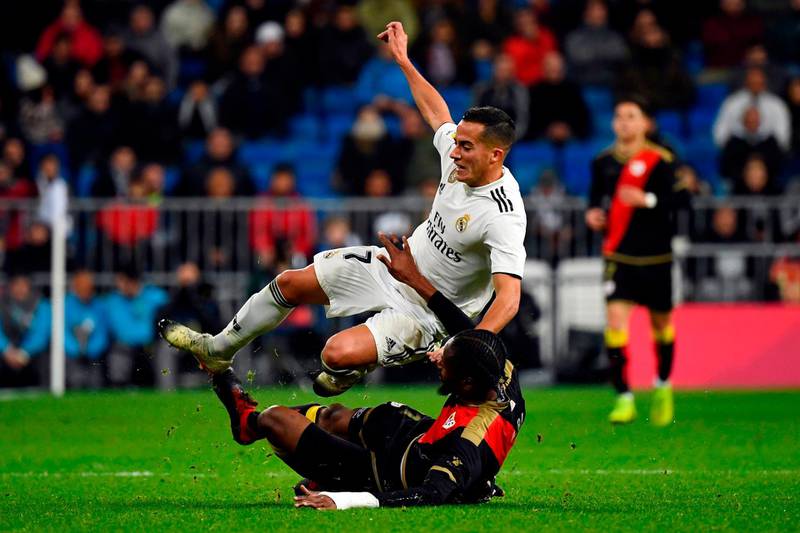 Real Madrid midfielder Lucas Vazquez is tackled by Rayo Vallecano defender Abdoulaye Ba. AFP