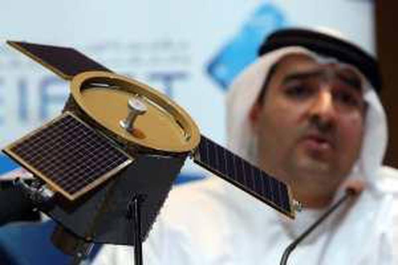 DUBAI. 4th August. 2009. DUBAISAT-1 LAUNCH. His Excellency Ahmed Al Mansoori, Director General of EIAST( Emirates Institute for Advanced Science and Technology) with a model of the DubaiSat-1 satellite at a press conference in Dubai yesterday(tues) to announce the successful launch of the satelite. Stephen Lock  /  The National .  *** Local Caption ***  SL-satelite-001.jpg