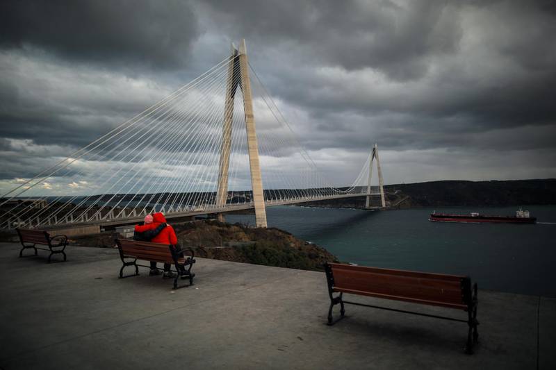 People enjoy the view next to the Yavuz Sultan Selim Bridge over the Bosphorus Strait in Istanbul.  AP Photo