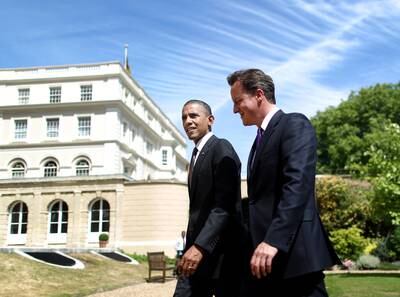 Mr Cameron and US President Barack Obama walk in the gardens of Lancaster House in 2011. Getty Images