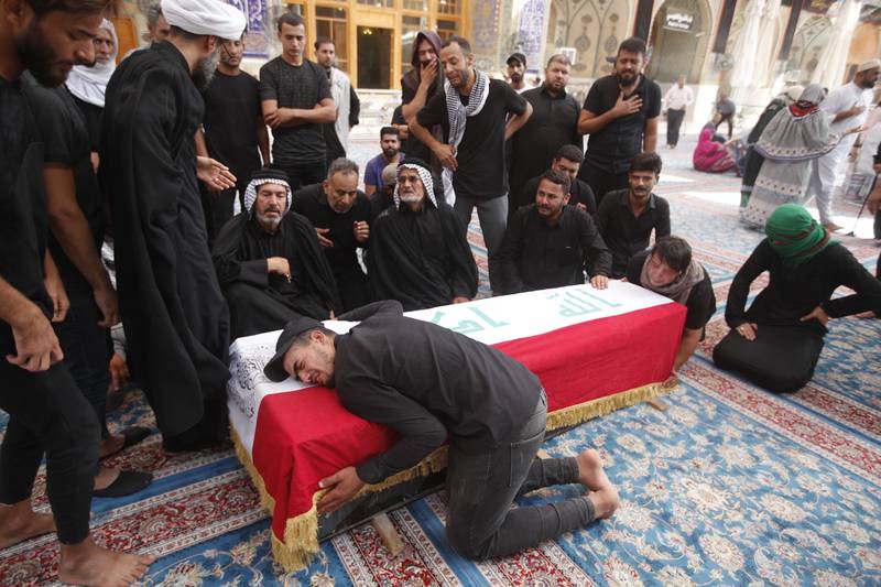 Relatives attend the funeral of a man killed during clashes with security forces in Baghdad. AP