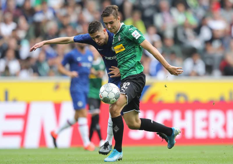 Florian Neuhaus of Borussia Monchengladbach is challenged by Jorginho of Chelsea.
