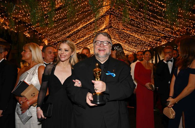 Mexican director Guillermo del Toro, winner of the Oscar for Best Animated Feature Film for Pinocchio, wears his blue ribbon at the Governor's Ball. AFP