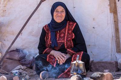 A Bedouin woman selling tea waits for customers at the reopened Petra archeological site. EPA