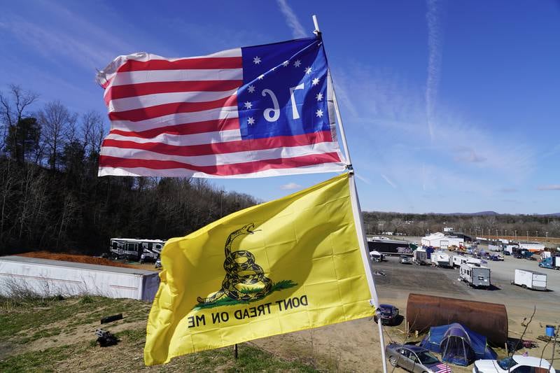 A 'Don't tread on me' flag and the Bennington flag wave in the wind above the People's Convoy in Hagerstown, Maryland. All photos: Willy Lowry / The National.